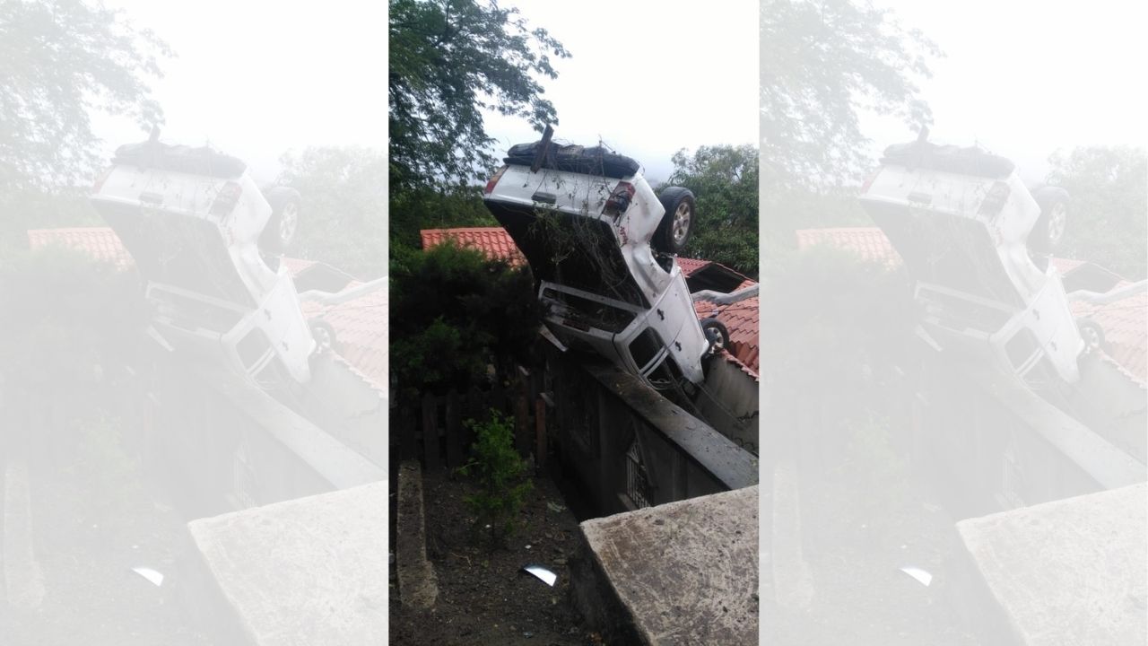 Agentes de la DPI se accidentan en vehículo que cayó en el techo de una casa en la carretera hacia Olancho