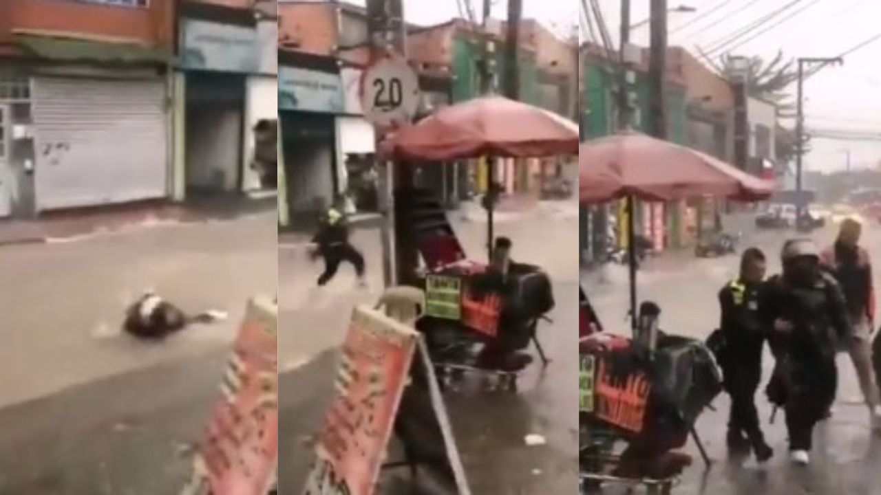 ¡Heroico rescate! Policía salva a motociclista, que era arrastrada por corriente de agua en Colombia