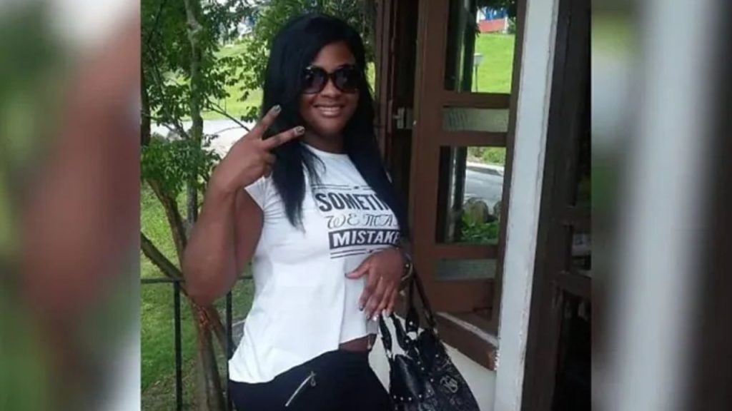 Dayle Ojeda viendo al frente haciendo la seña de amor y paz