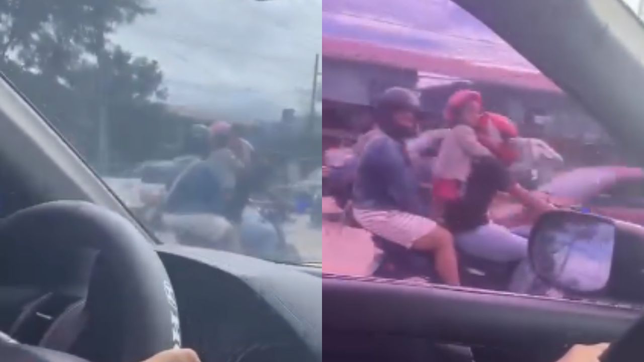 Graban a pareja en motocicleta con una niña parada entre ellos